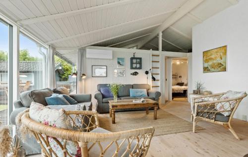 a living room with a couch and a table at 3 Bedroom Lovely Home In Ebeltoft in Ebeltoft