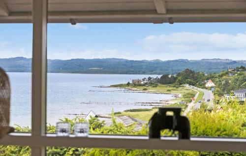 a view of the ocean from a window at 3 Bedroom Lovely Home In Ebeltoft in Ebeltoft