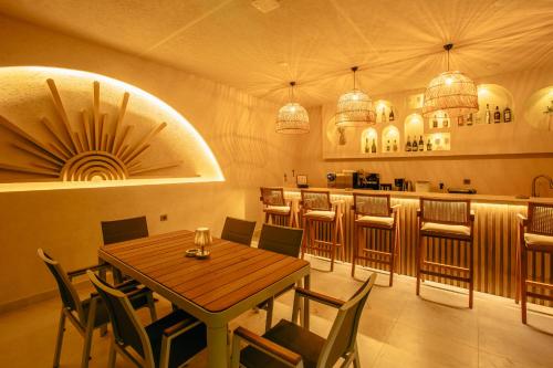 a restaurant with a table and chairs and a bar at Los Suites in Antalya