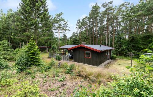 a small cabin in the middle of a forest at Pet Friendly Home In Kolind With Wifi in Kolind