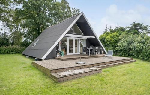 a small home with a gambrel roof and a deck at Gorgeous Home In Broager With Wifi in Broager