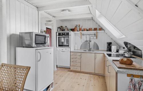 a kitchen with a white refrigerator and a microwave at Gorgeous Home In Broager With Wifi in Broager
