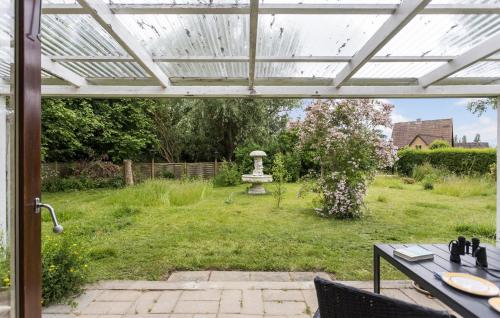 a patio with a white pergola and a garden at 3 Bedroom Awesome Home In Tranekær in Tranekær