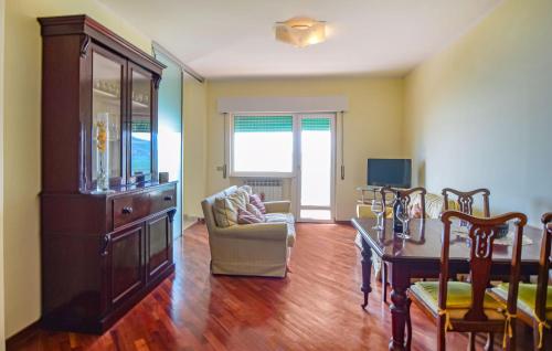 a living room with a couch a chair and a table at 2 Bedroom Nice Apartment In Orbetello in Orbetello