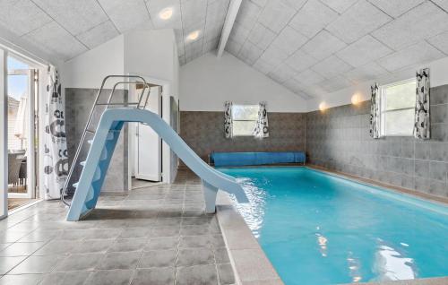 a indoor swimming pool with a slide in a room at Pet Friendly Home In Sydals With Sauna in Sønderby