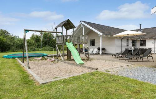 a playground in a yard with a slide at Pet Friendly Home In Sydals With Sauna in Sønderby
