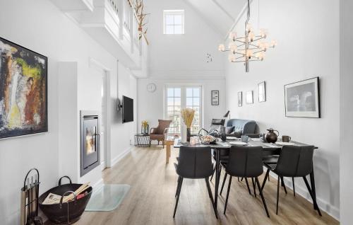 a dining room and living room with a table and chairs at Pet Friendly Apartment In Bagenkop in Bagenkop