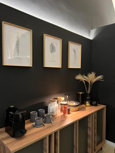 a wooden shelf with cups and pictures on the wall at Tussia in Brindisi
