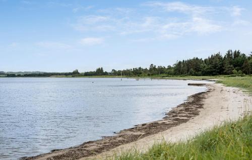 a beach next to a body of water at 3 Bedroom Cozy Home In Højslev in Højslev