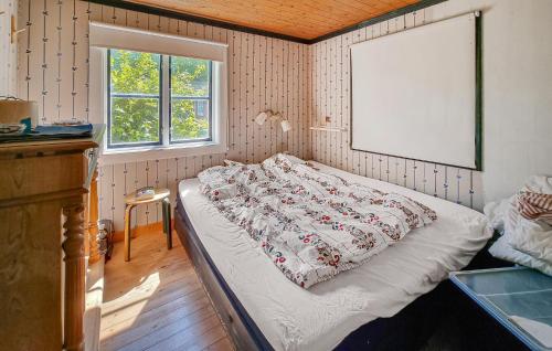 a bedroom with a bed and a window at 3 Bedroom Cozy Home In Mellerud in Mellerud