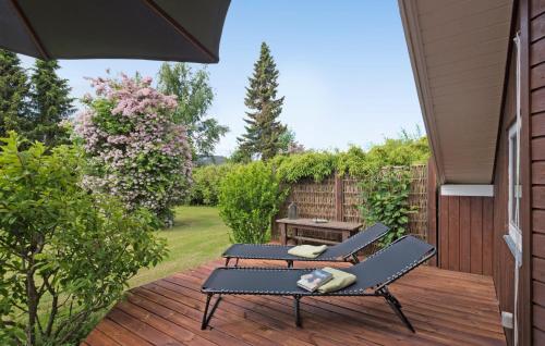 a patio with two chairs and a table on a deck at Cozy Home In Rødvig Stevns With Wifi in Rødvig
