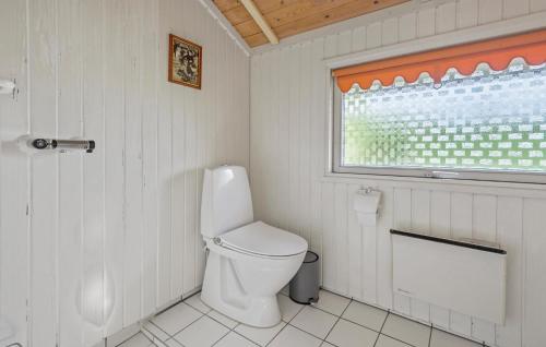 a white bathroom with a toilet and a window at Cozy Home In Rødvig Stevns With Wifi in Rødvig