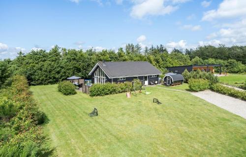 a house with a yard with birds in the grass at Gorgeous Home In Tarm With Kitchen in Tarm