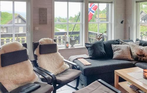 a living room with a couch and chairs and windows at 3 Bedroom Beautiful Home In Åseral in Åseral