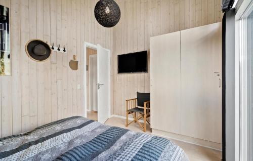 a bedroom with a bed and a tv on the wall at Gorgeous Home In Tarm With Kitchen in Tarm