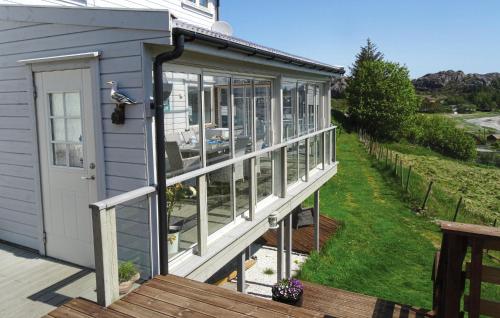 a screened in porch on a house at Cozy Home In Hellvik With Wifi in Hellvik