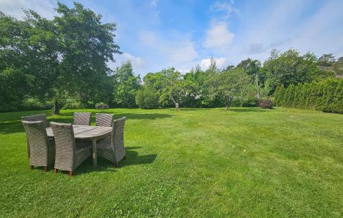 a table and chairs in a field of grass at 2 Bedroom Stunning Apartment In Tjøme in Tjøme