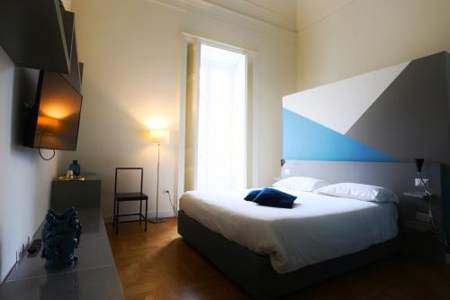 Postel nebo postele na pokoji v ubytování Teatro Suites Rooms