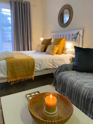 a room with two beds and a candle on a table at Seaside Vacation Studio @ Shearwater Myoli Beach in Sedgefield