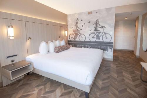 a bedroom with a large white bed in a room at Coast Victoria Hotel & Marina by APA in Victoria