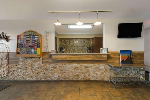 a lobby of a store with a tv on the wall at SureStay by Best Western Camp Verde in Camp Verde