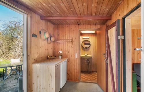 a kitchen with a sink and a wooden wall at Gorgeous Home In Kalundborg With Wifi in Kalundborg