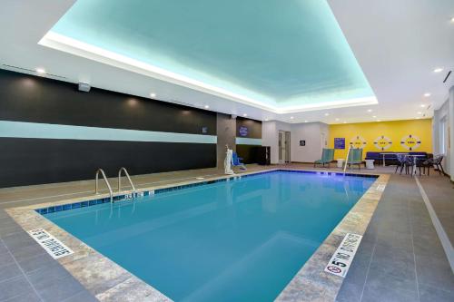 a large swimming pool in a hotel room at Tru By Hilton Wake Forest Raleigh North in Wake Forest