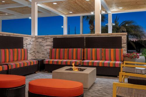 a patio with two chairs and a fire pit at Home2 Suites By Hilton Savannah I95 North in Port Wentworth
