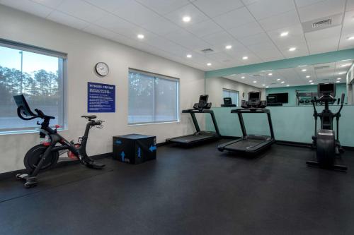a gym with bikes and exercise equipment in a room at Tru By Hilton Wake Forest Raleigh North in Wake Forest