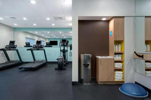 a gym with treadmills and machines in a room at Tru By Hilton Wake Forest Raleigh North in Wake Forest