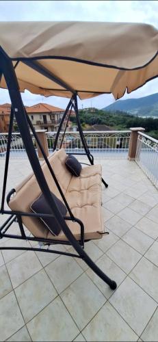 a chair under an umbrella on a roof at Attico Morette, terrazzo - whazapp tre due 0 26 ott ott sei 2 quattro in Boissano