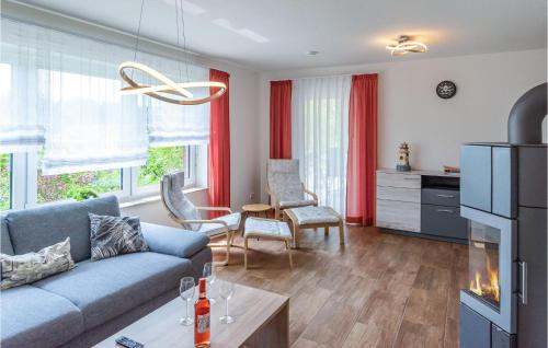 a living room with a blue couch and red curtains at Beautiful Home In Bleckede With Wifi in Bleckede