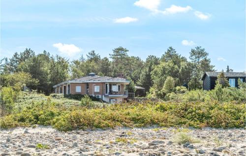 a house on the beach with trees in the background at 6 Bedroom Gorgeous Home In Gilleleje in Gilleleje