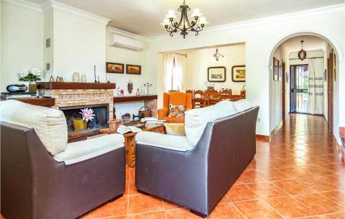 a living room with two chairs and a fireplace at Cozy Home In El Gastor in El Gastor