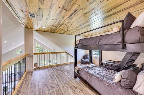 two bunk beds in a room with wooden ceilings at Riverfront Murfreesboro Cabin with Fire Pit in Nashville