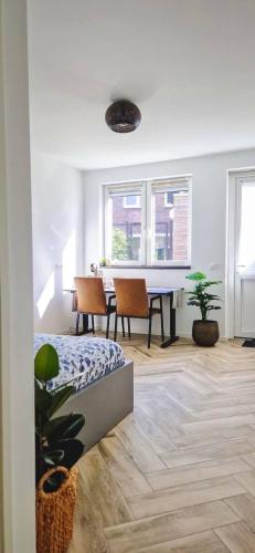 a living room with a table and chairs and a bed at Modern & Convenient Studio in Arnhem
