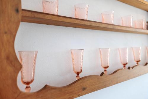 a row of wine glasses on a shelf at La Quinta da Liberdade - Ferme de charme en Algarve in Pechão
