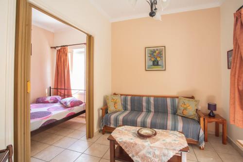 a living room with a couch and a mirror at GAIA The Cottage House in Nydri