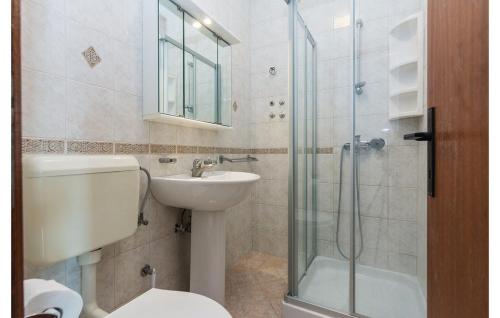 a bathroom with a toilet and a sink and a shower at Seaside apartments with a swimming pool Nin, Zadar - 6153 in Nin