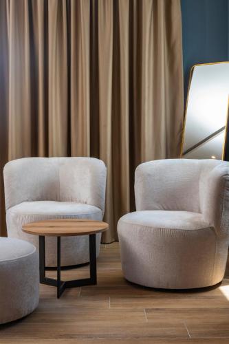 two chairs and a coffee table in a room at POSEIDON Seaview Presidential in Paralia Katerinis