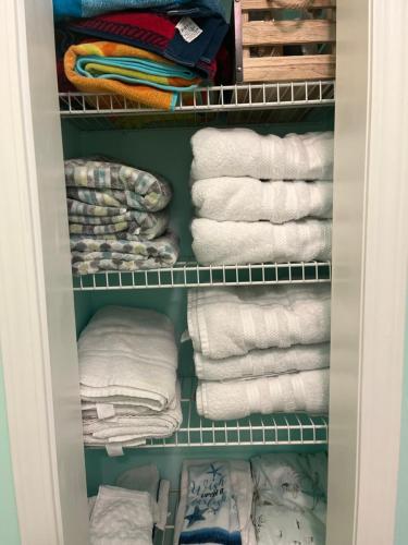 a closet filled with towels and towels at Beach access close to Walmart, Bowling,skating and Game room in Panama City Beach