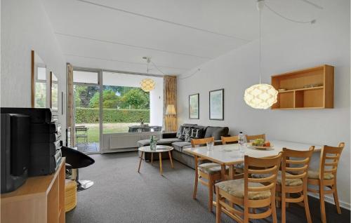 a living room with a table and a couch at Stunning Apartment In Faaborg in Fåborg