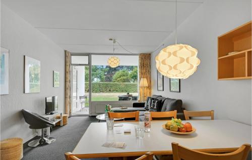 a kitchen and living room with a table and chairs at Stunning Apartment In Faaborg in Fåborg