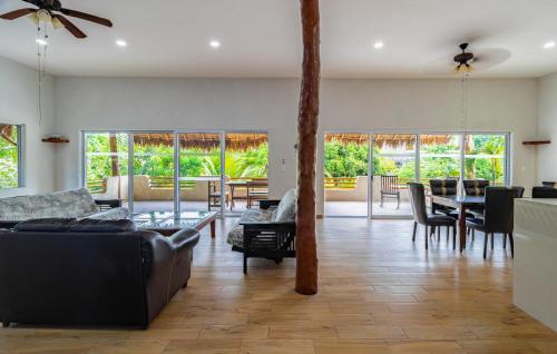 a living room with couches and a table and chairs at Hotel & Suites Oasis Bacalar in Bacalar