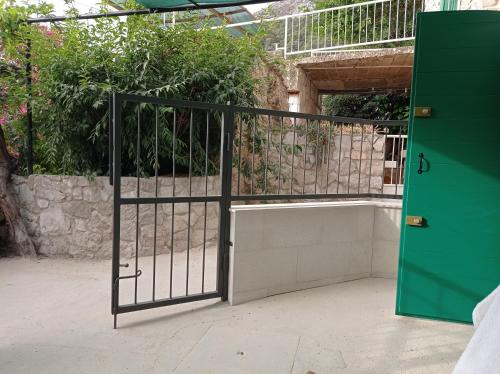 an open gate in a building with plants on it at Apartments with WiFi Pitve, Hvar - 22114 in Jelsa