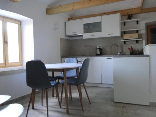 a kitchen with a table and chairs in a room at Apartments with WiFi Pitve, Hvar - 22114 in Jelsa