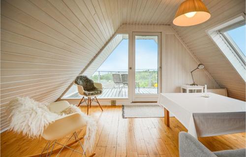 a room with an attic with a table and chairs at Holiday Home Ebeltoft V in Ebeltoft