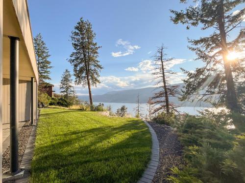 a walkway next to a house with a view of the water at Kelowfornia Lakeview Retreat in Kelowna