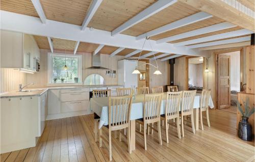 a kitchen and dining room with a table and chairs at Jægerstuen in Bedegård