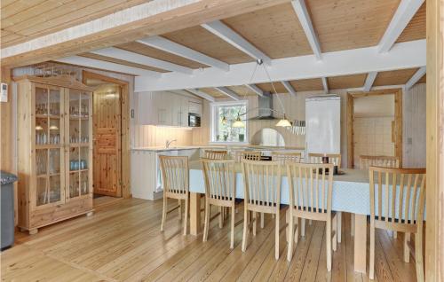 a kitchen with a table and chairs in a room at Jægerstuen in Bedegård